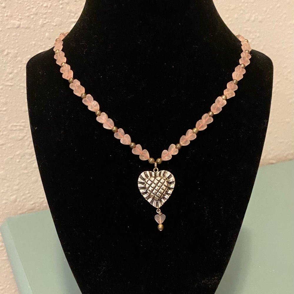 Tiny pink rose quartz hearts with silver pendant.